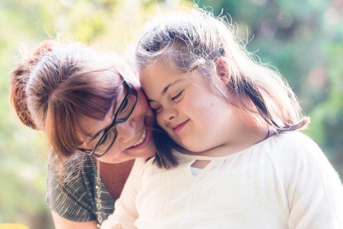 Portrait of mother with her daughter with Down Syndrome.